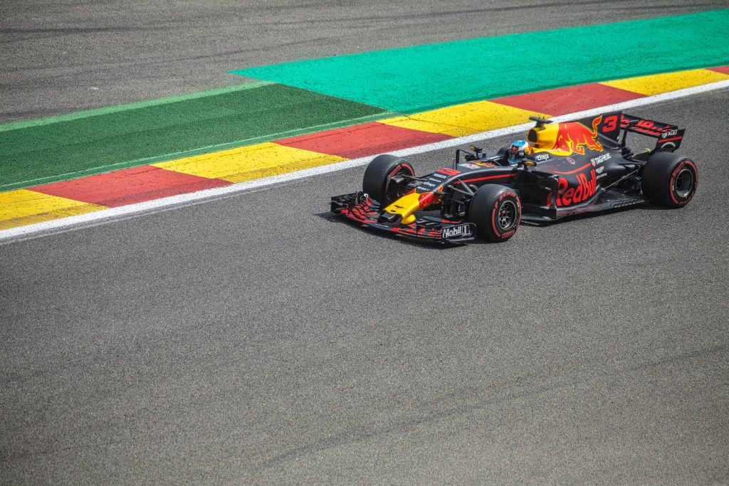 black and yellow Red Bull F1 racing in concrete track