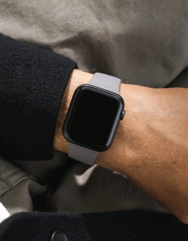 apple watch on a dark grey wristbuddys silicone band with integrated adapter, on the wrist