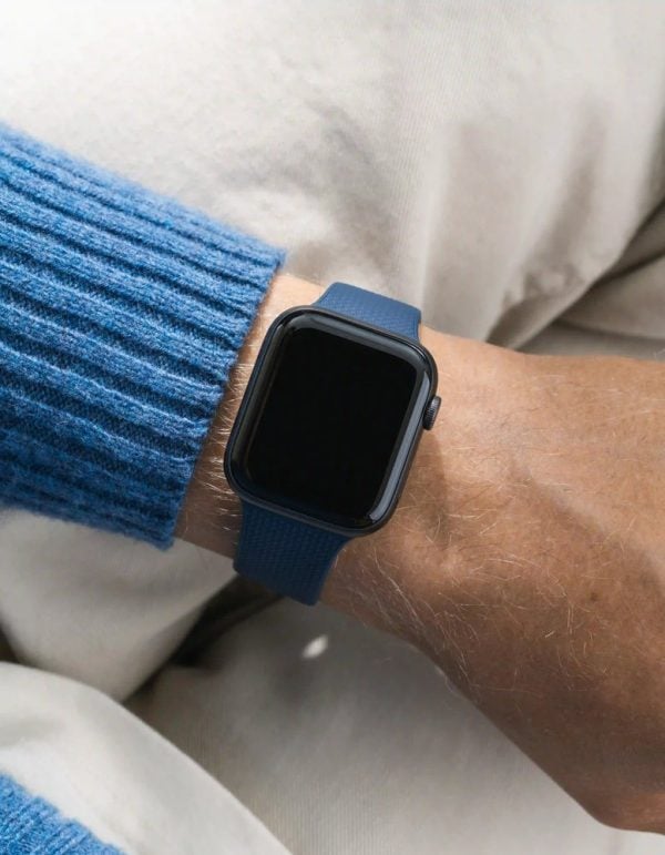 apple watch on a navy blue wristbuddys silicone band with integrated adapter, on the wrist