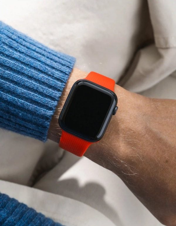 apple watch on a red wristbuddys silicone band with integrated adapter, on the wrist