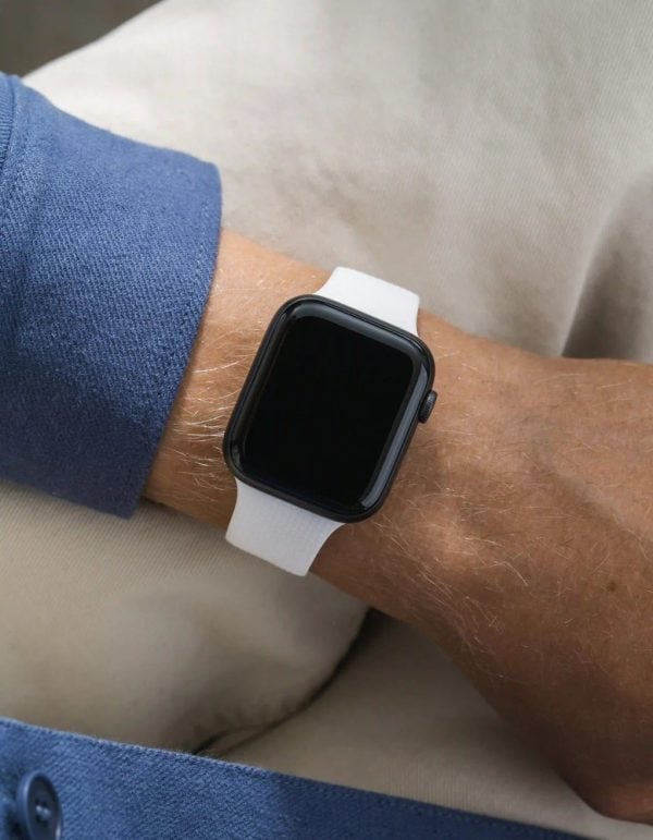 apple watch on a white wristbuddys silicone band with integrated adapter, on the wrist